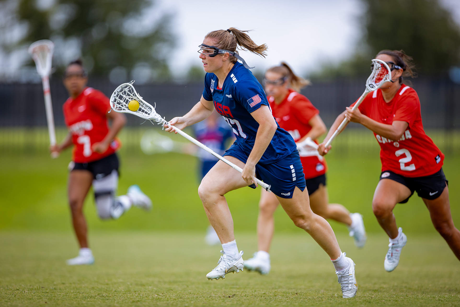 Izzy Scane runs with the ball against Canada during the PALA championship