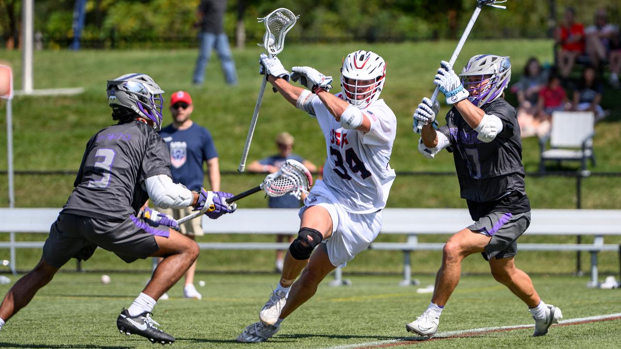 Ryan Terefenko splits two Haudenosaunee defenders during the Atlas Cup