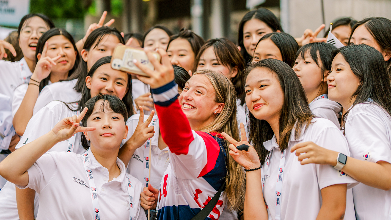 Madison Taylor takes a selfie with Team Korea during opening ceremonies at the World Lacrosse Women's U20 Championship in Hong Kong, China.