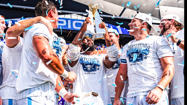 New York Atlas captain Trevor Baptiste hoists the PLL championship trophy during a celebration at Sports Illustrated Stadium in Harrison, N.J.